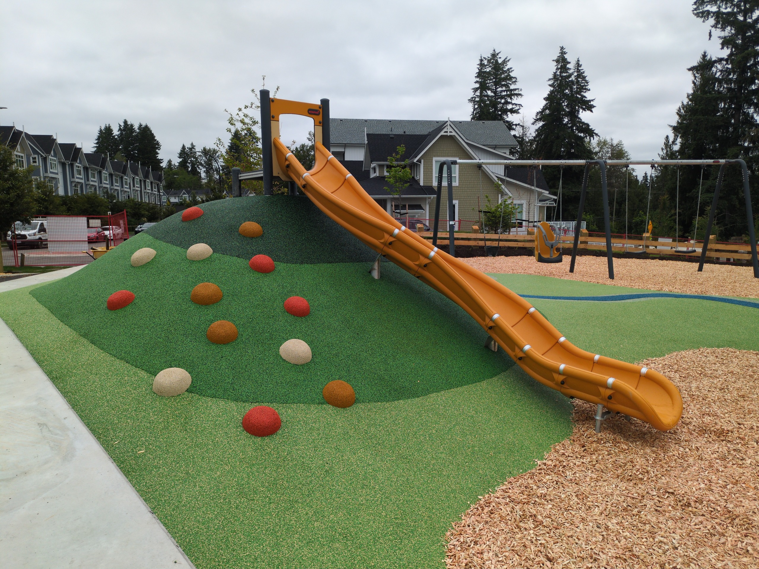 Tall yellow hill-slide on a green rubber hill